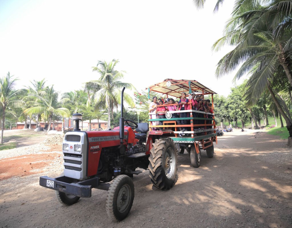Students enjoying a tractor ride during a school picnic at NatureNestt Agro Tourism near Pune